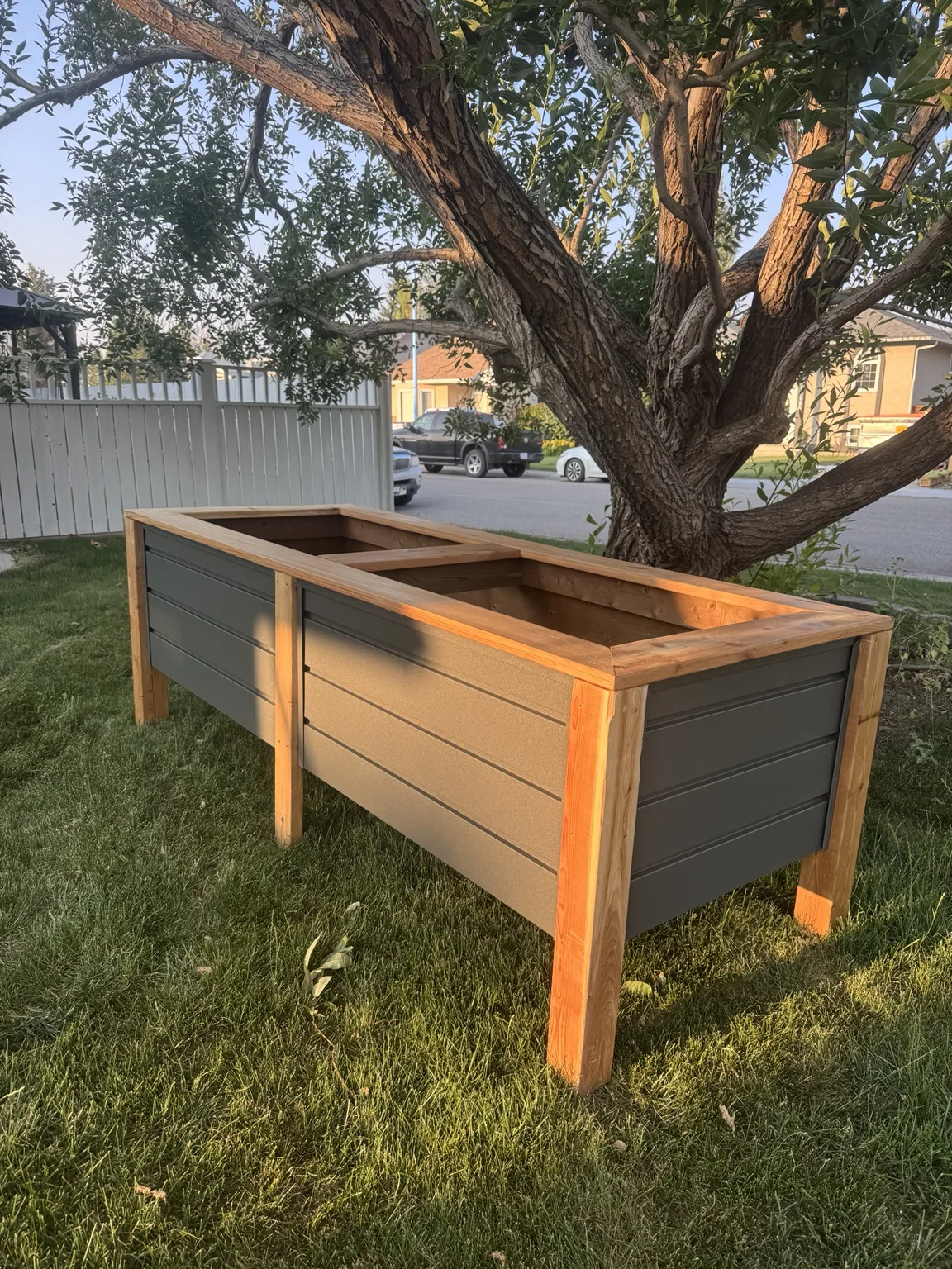 Custom raised planter with wood framing and dark panels