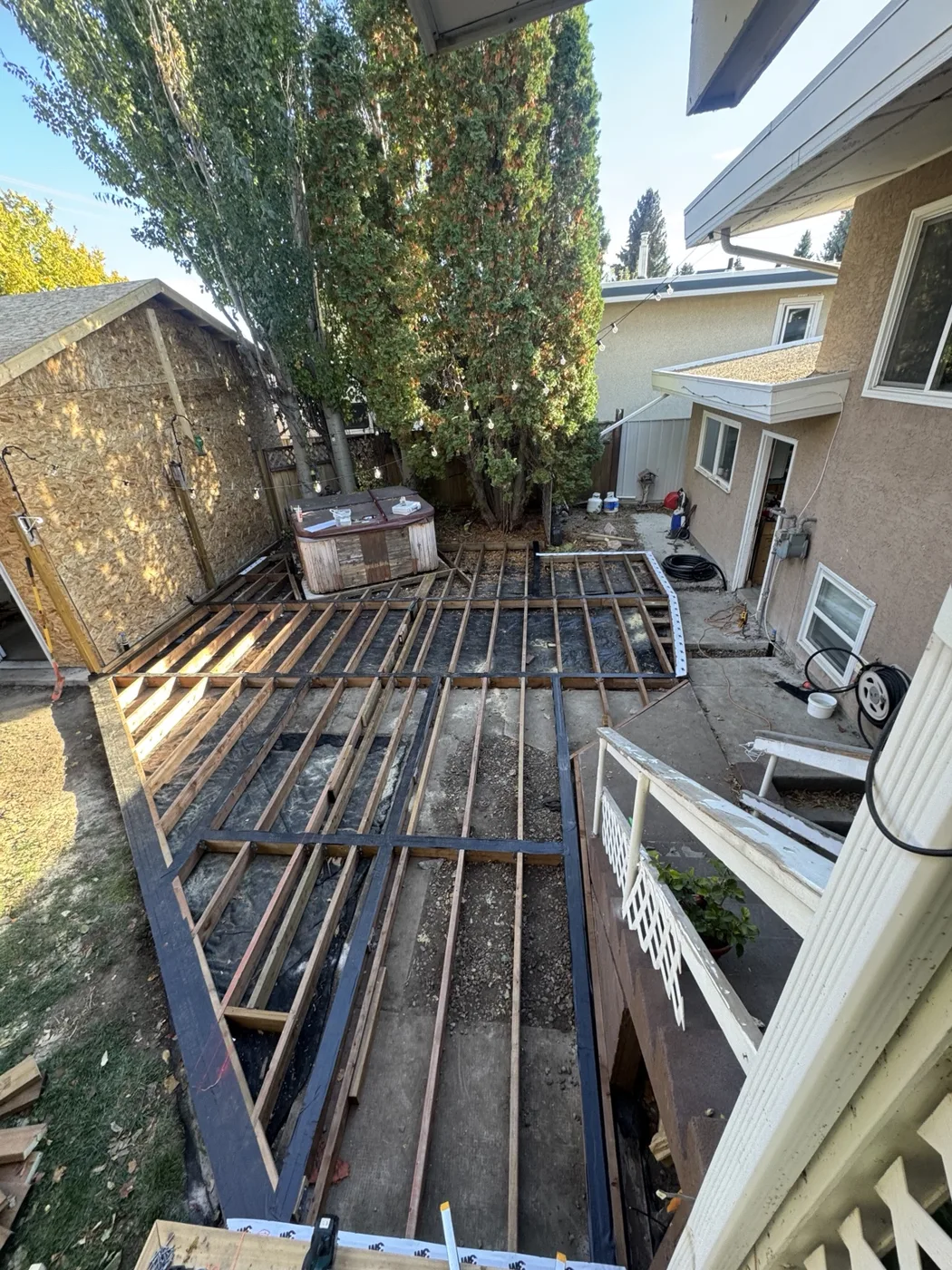 Deck framing in progress showing joists and structure